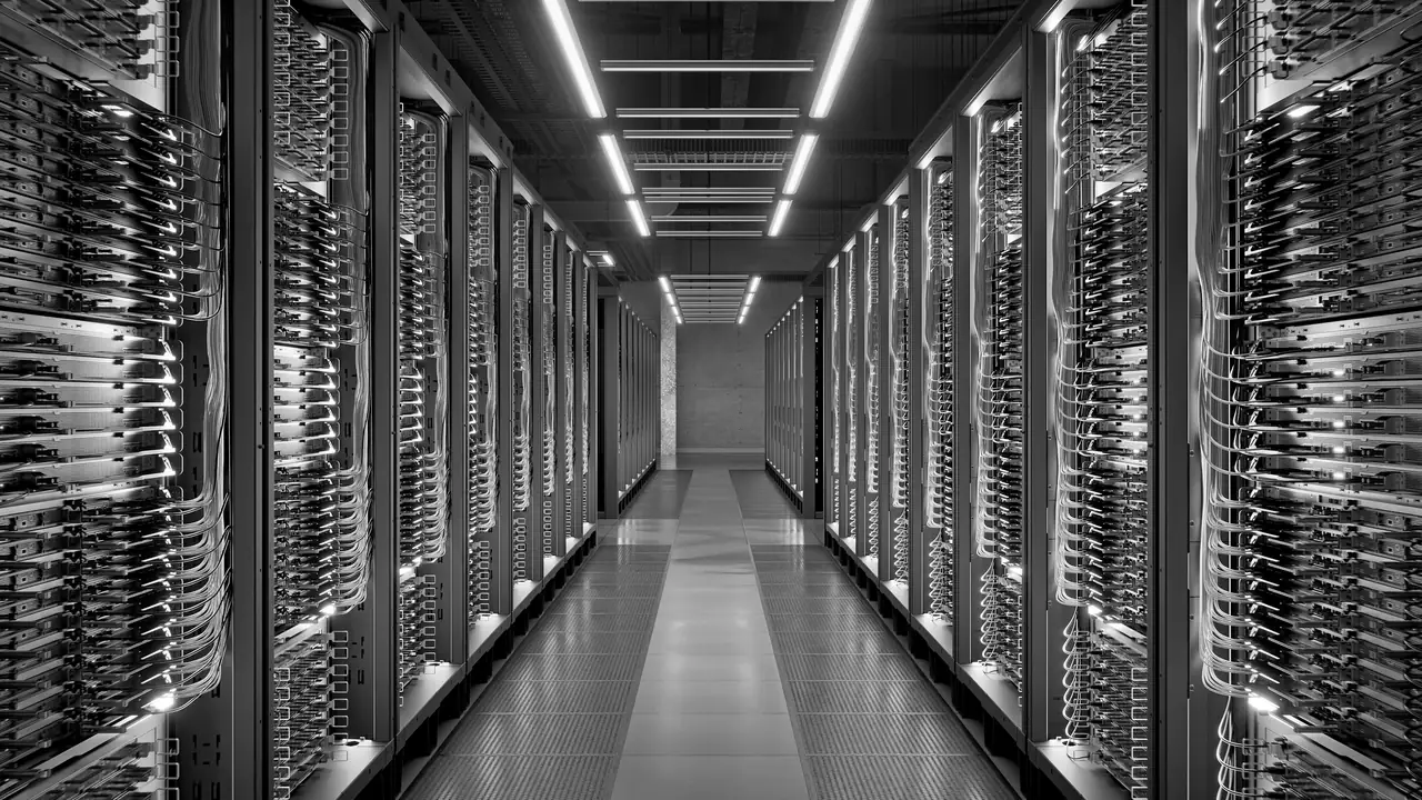 Rendered view down a data-centre aisle between cabled server racks